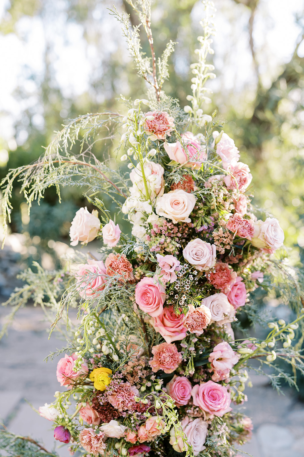wedding arch with roses and various flowers