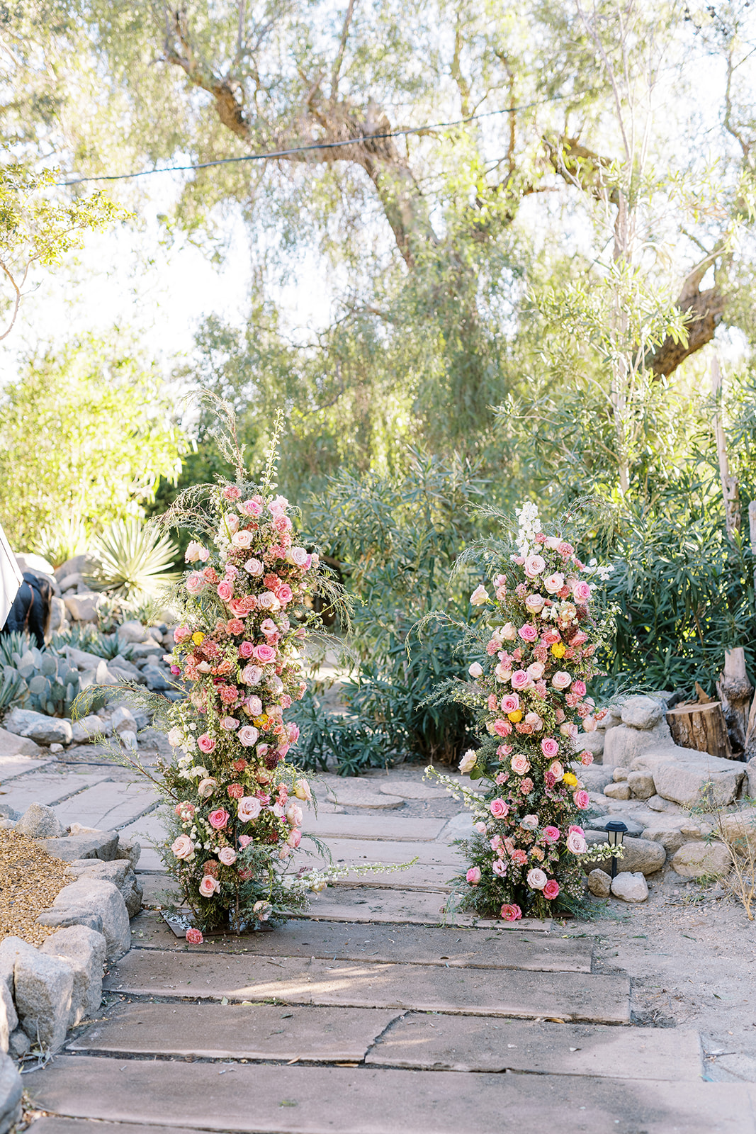 wedding arch with roses and various flowers