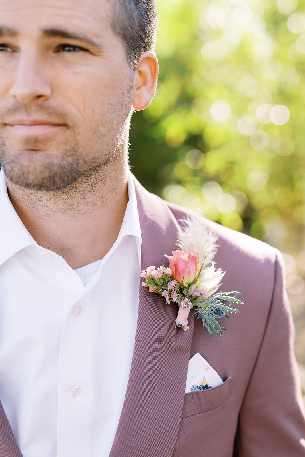 man looking distance with mauve suit 