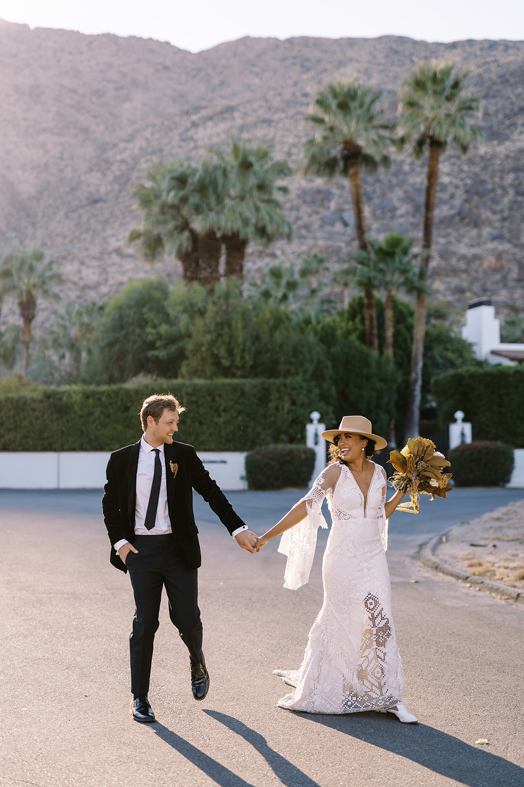 Man and woman in the middle of the road while holding hands and after they had their desert elopement. 
