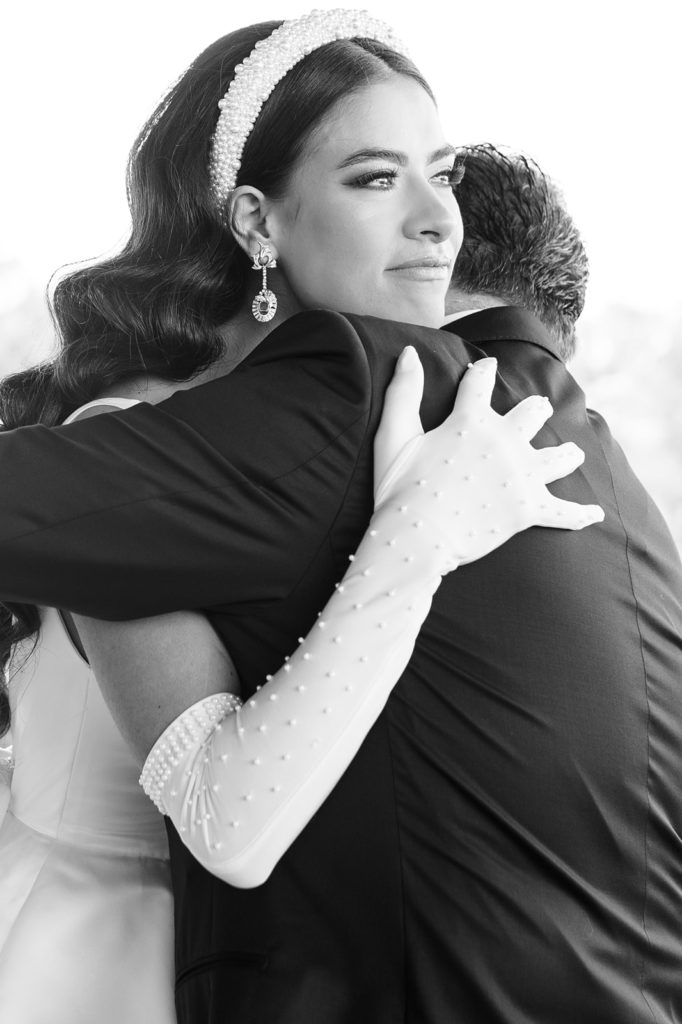 Bride and Bride's father crying and emotional during first look for wedding.