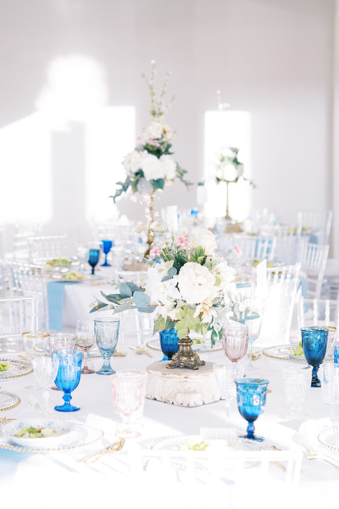 Simple clear and blue details for wedding reception table decor.