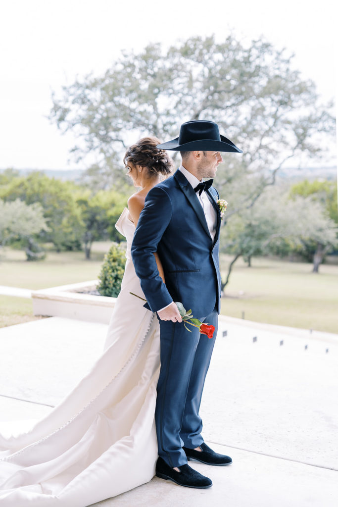 bride and groom first look pictures outside at gorgeous texas wedding venue