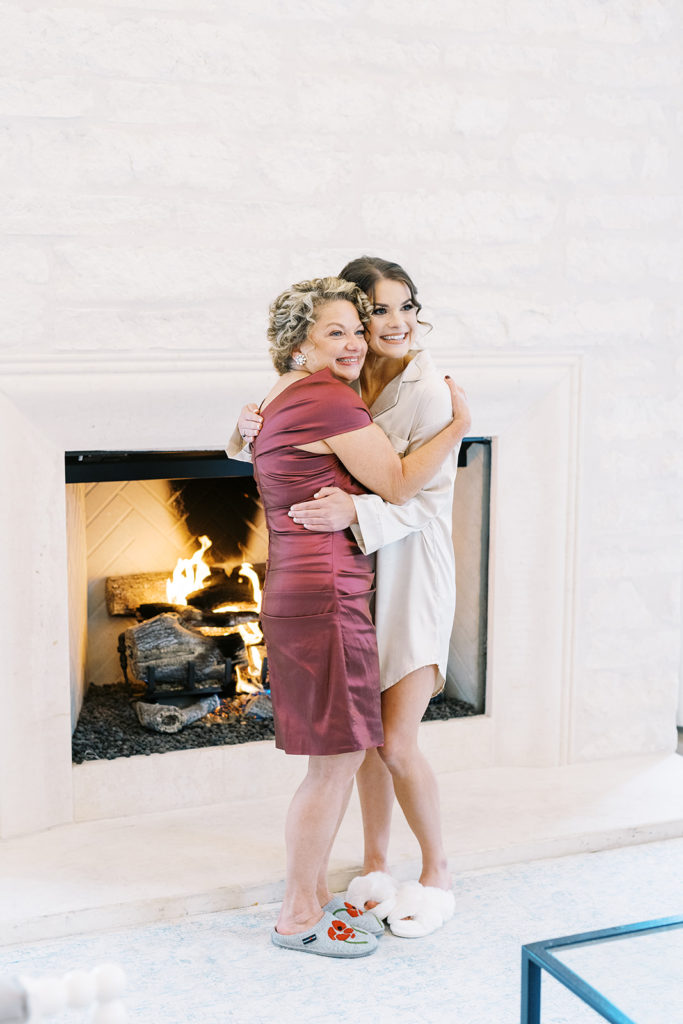 mother and bride hugging eachother and smiling