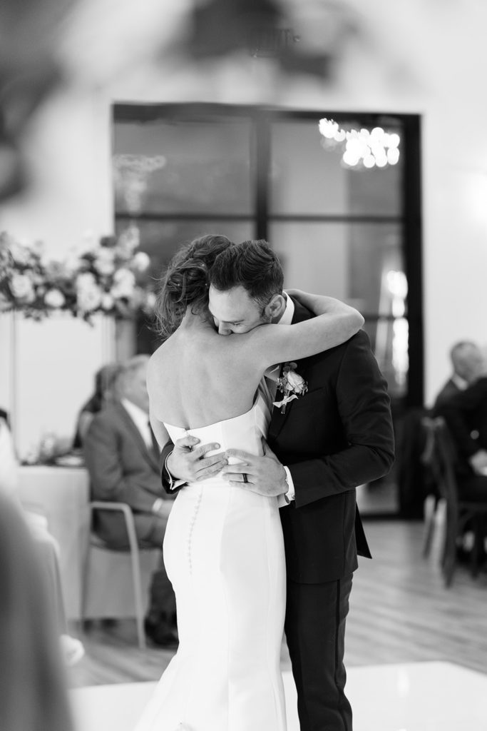 Bride and groom holding eachother during ceremony at gorgeous texas wedding venue