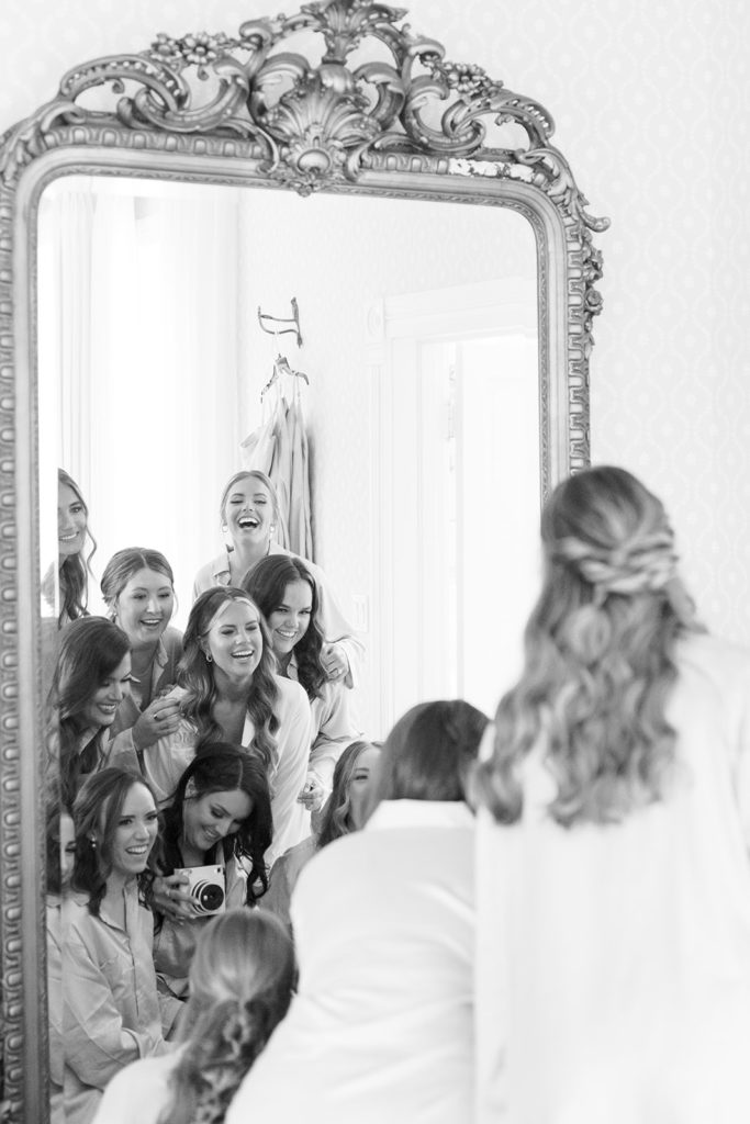 bridal party having fun in mirrors that were in bridal party suite